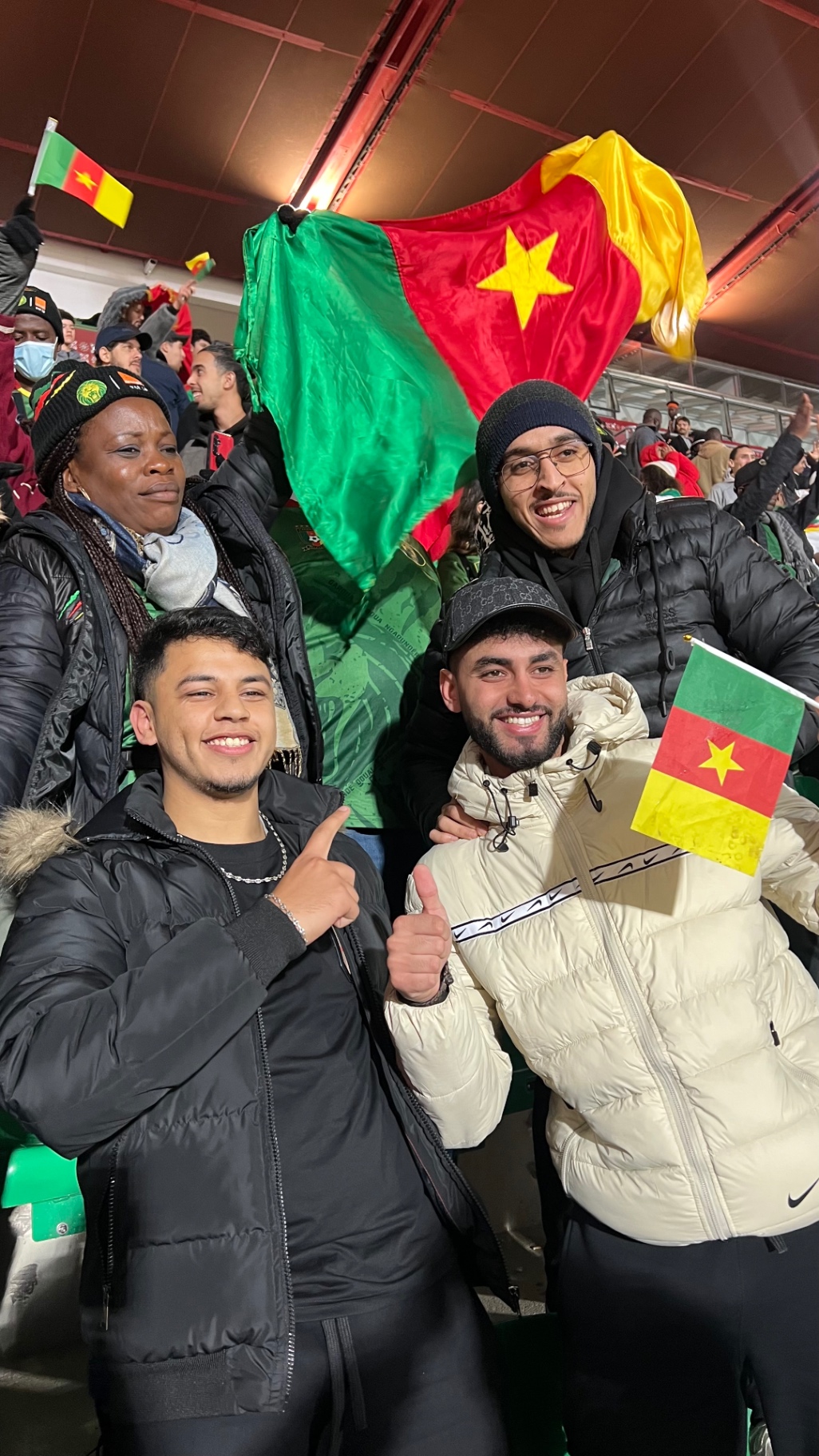 Supporters celebrating with Cameroon flags in the stands