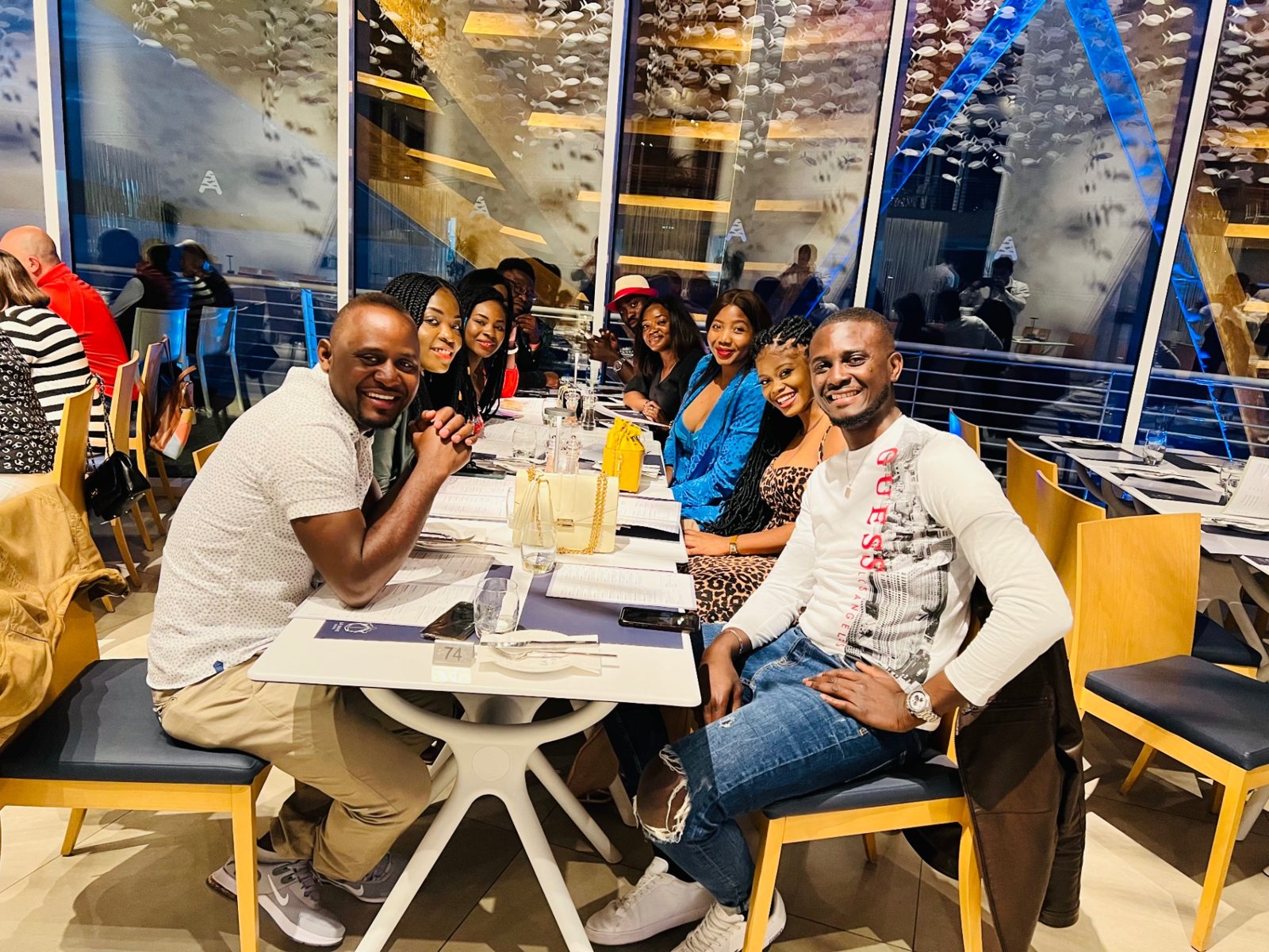 FlyWithRogers travelers sharing a group dinner together at a restaurant